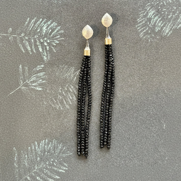 Black spinel beaded tassels hanging from silver and gold posts