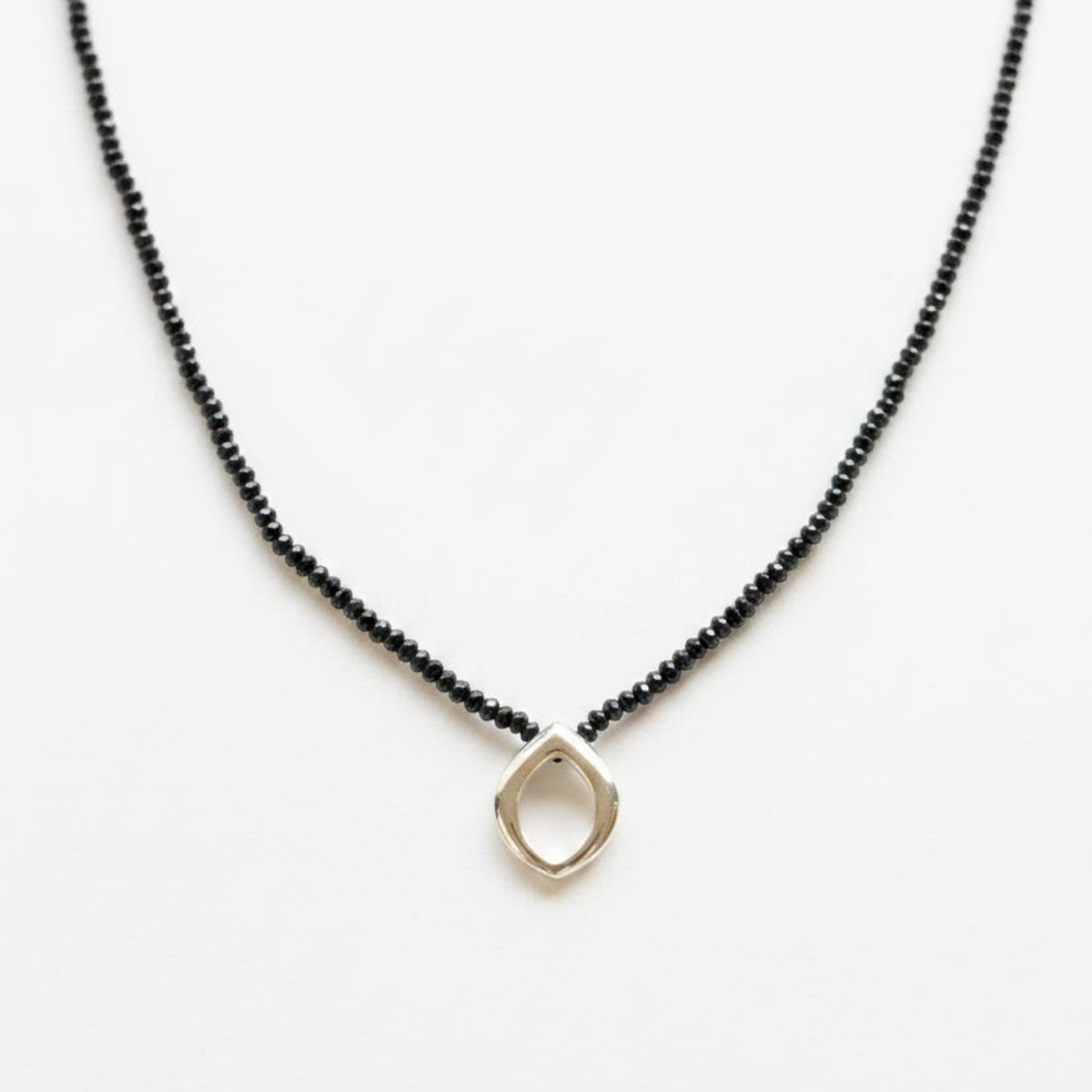 Necklace with a sterling silver clasp on a black spinel strand and Bud pendant