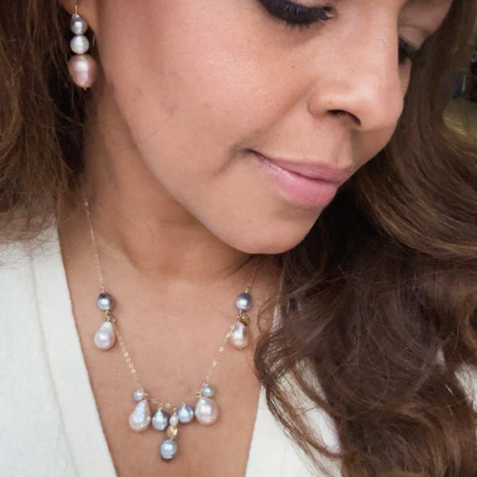 Close-up of a woman wearing a pearl necklace and earrings.