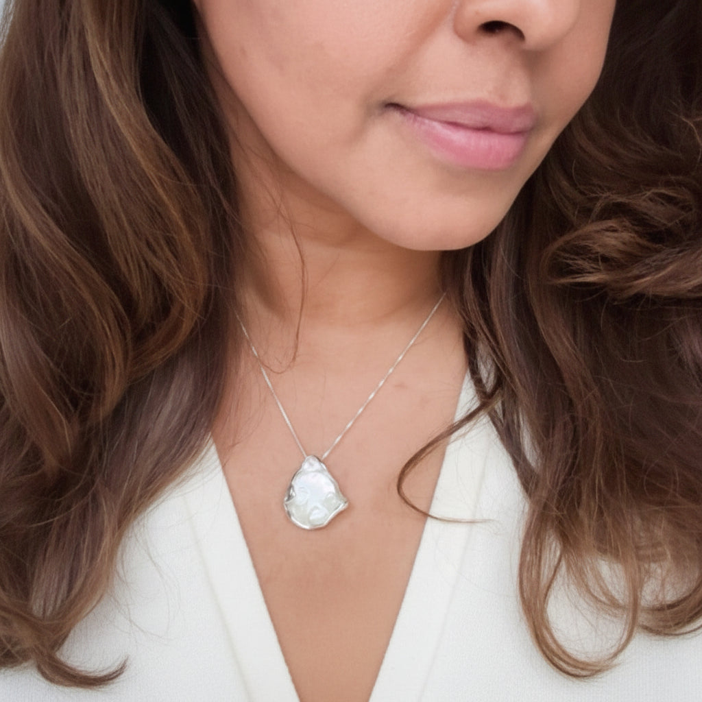 Necklace with a large, baroque shaped coin pearl pendant on model