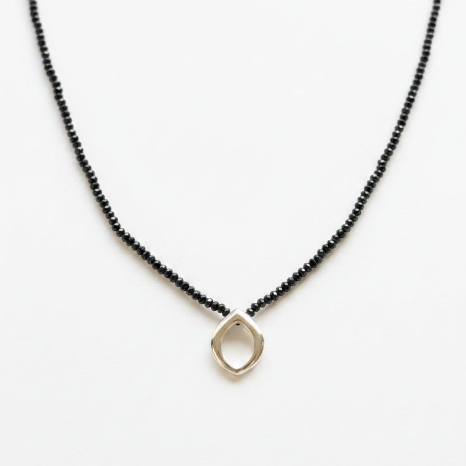 Necklace with a sterling silver clasp on a black spinel strand and Bud pendant
