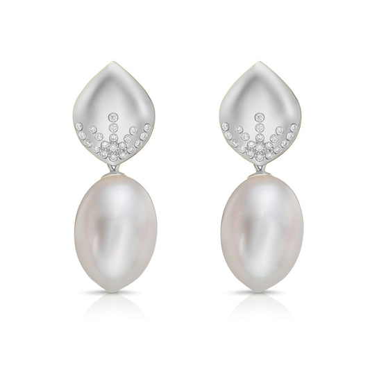 Pearl and diamond earrings on a white background