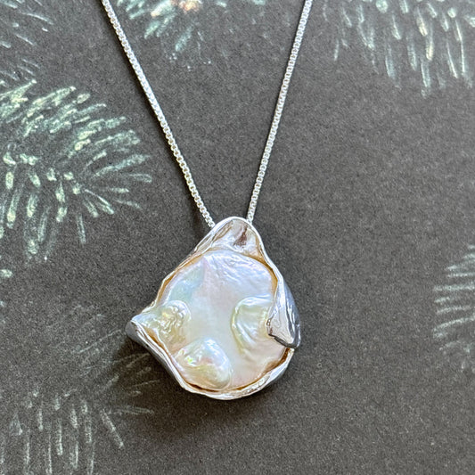 Necklace with a large, baroque shaped coin pearl pendant 