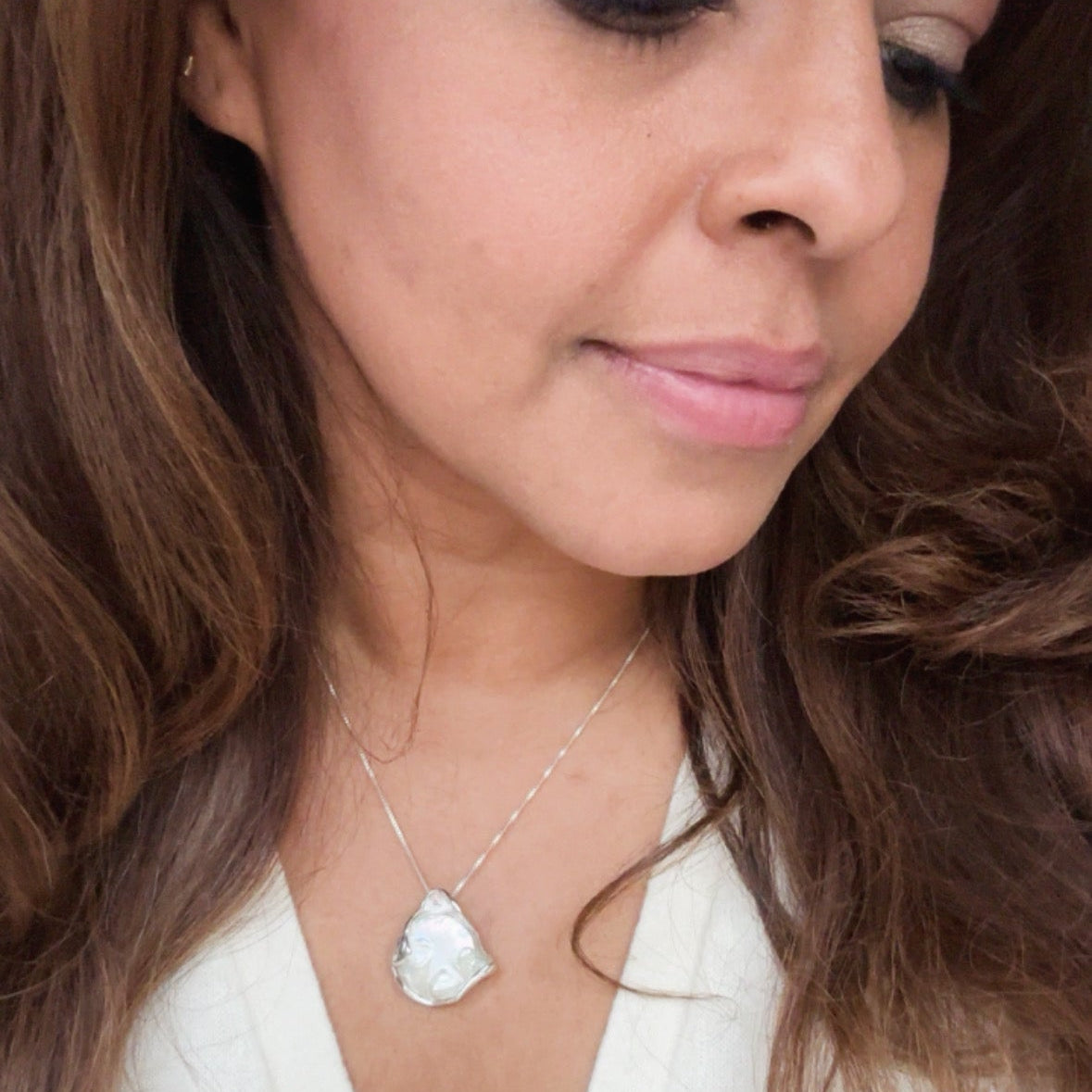 Necklace with a large, baroque shaped coin pearl pendant on model