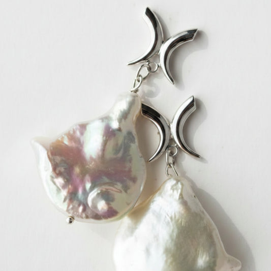 A pair of baroque pearl earrings with sterling silver X shape studs 